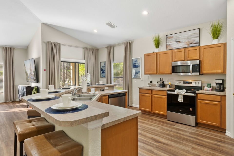 Family-Ready Kitchen – A fully stocked kitchen with stainless-steel appliances, breakfast bar seating, and plenty of space for preparing meals together.