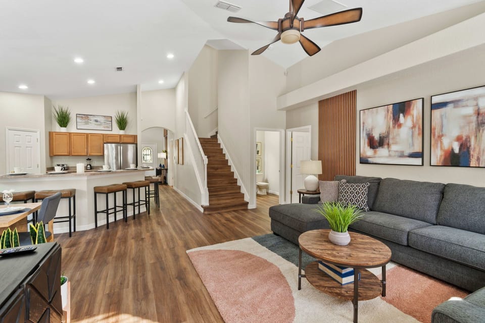Spacious Living Area – Bright open-concept layout with cozy seating, modern décor, and direct flow into the kitchen and dining area.