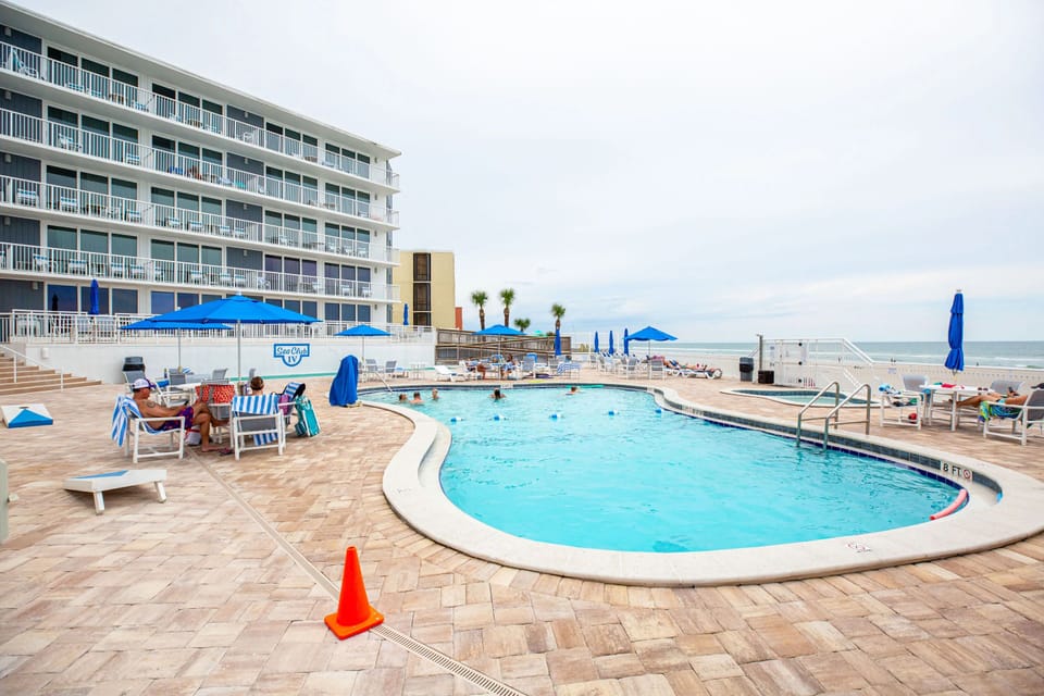 Relax by the sparkling pool with ocean views, perfect for enjoying a sunny afternoon at Sea Club IV Resort.