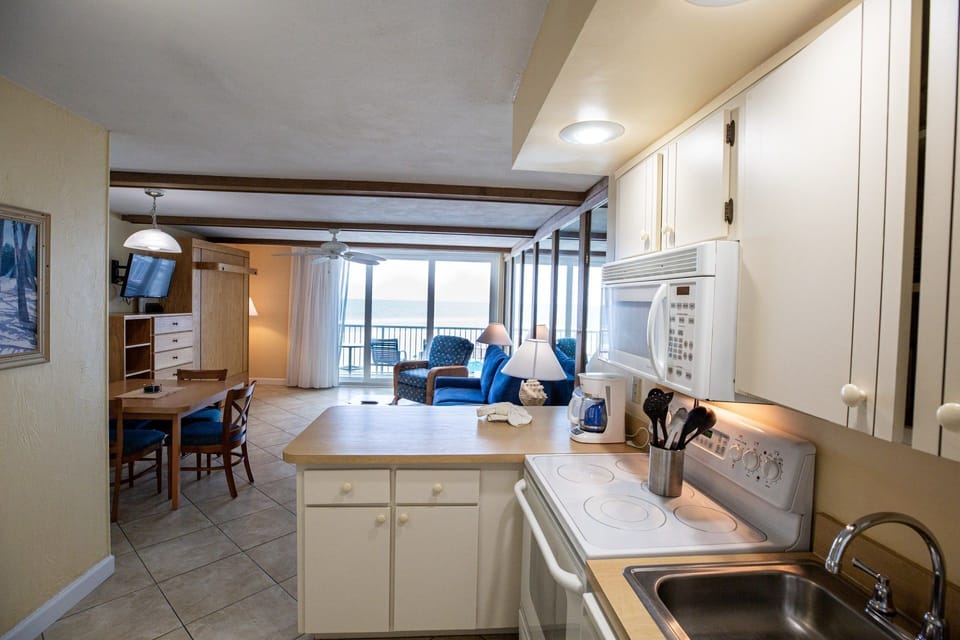 A well-equipped kitchenette with ocean views ensures that preparing meals is as enjoyable as dining on the private balcony.
