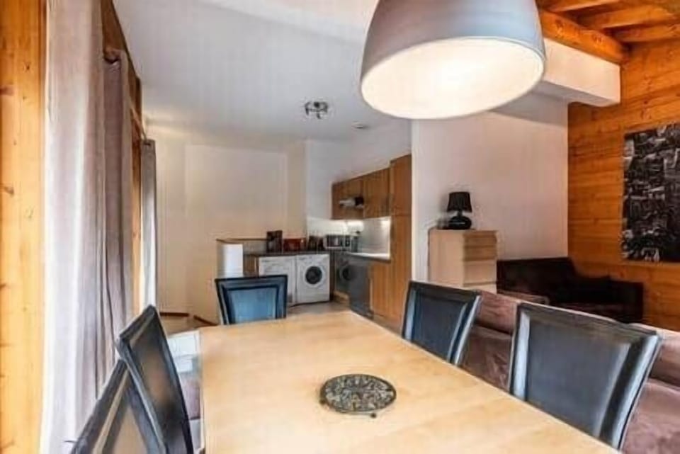 Dining area with kitchen in background
