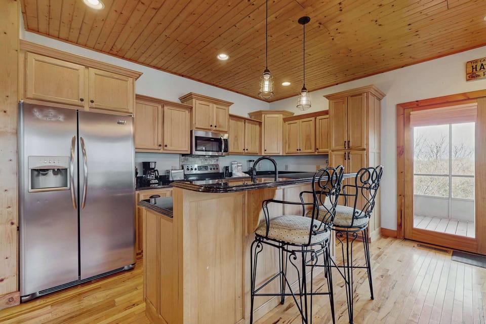 Whip up gourmet meals in this stylish kitchen with stunning views!