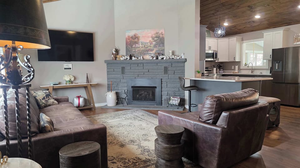 Relax by the stylish fireplace with contemporary decor and inviting seating for all!