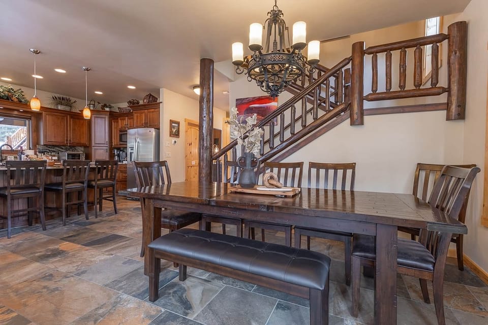 Main-level great room, dining area, and kitchen flow seamlessly in warm mountain style