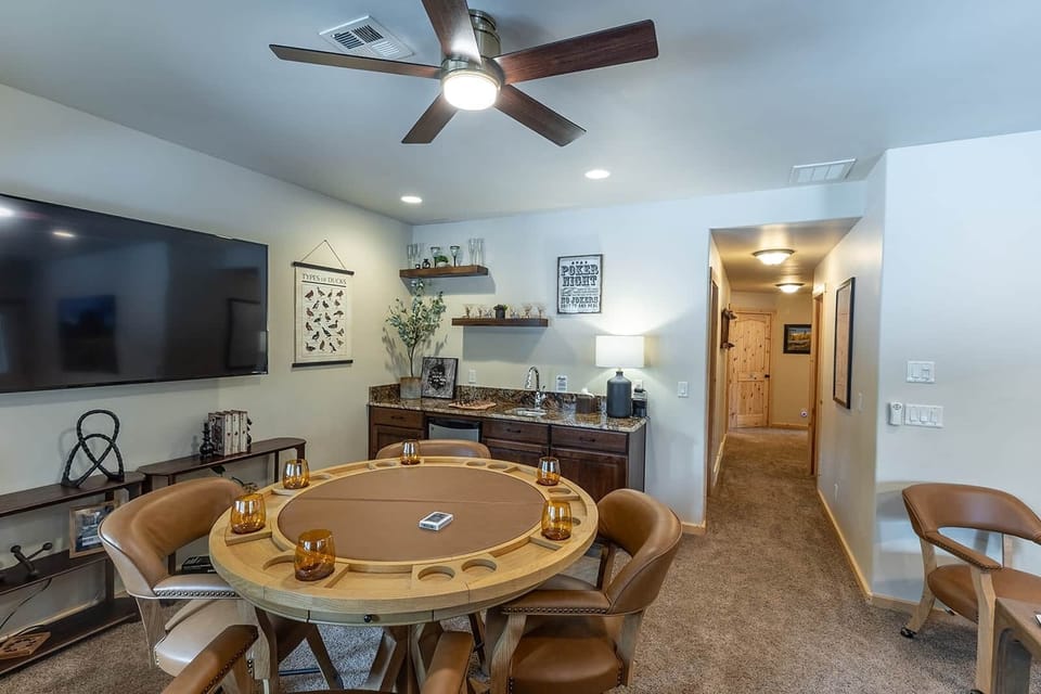Entertainment lounge with wet bar, dual smart TVs, poker table, games, great for gathering