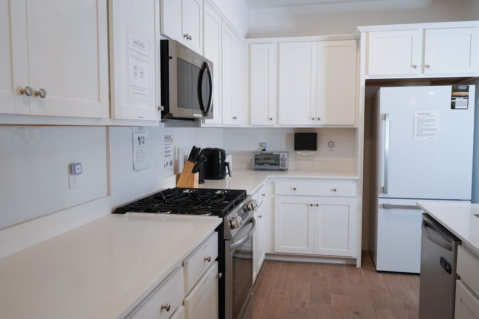 An open kitchen with ample countertops, plenty cabinet space, and appliances.