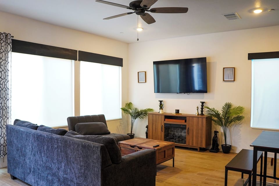 Bright living room with big windows, lots of light,  and comfy seating.