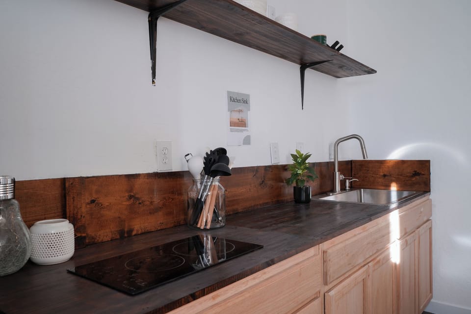 Two burner cooktop, deep sink and dedicated cook space.
