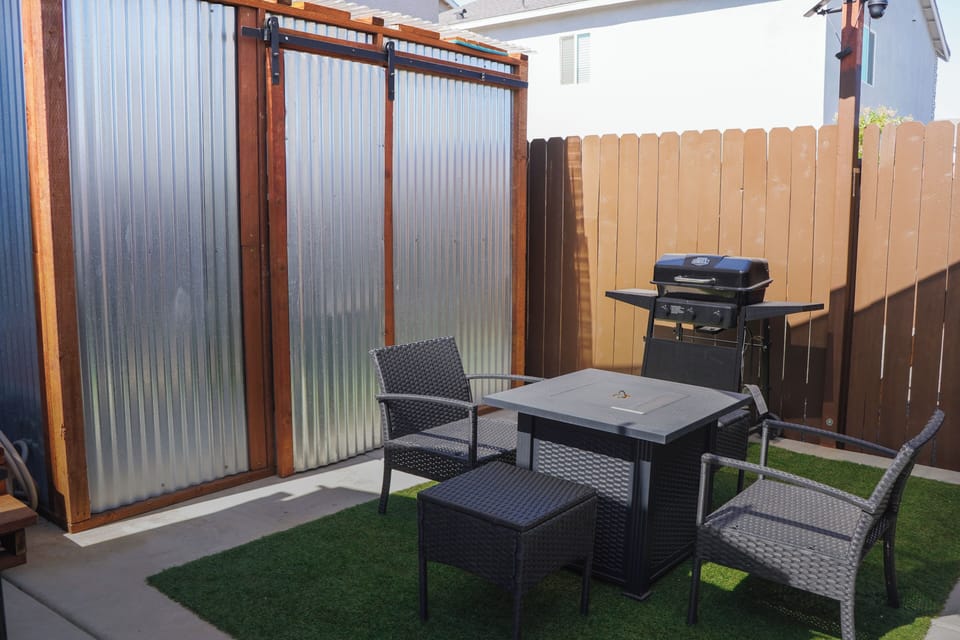 Private backyard and patio featuring a cozy fire pit & BBQ grill.