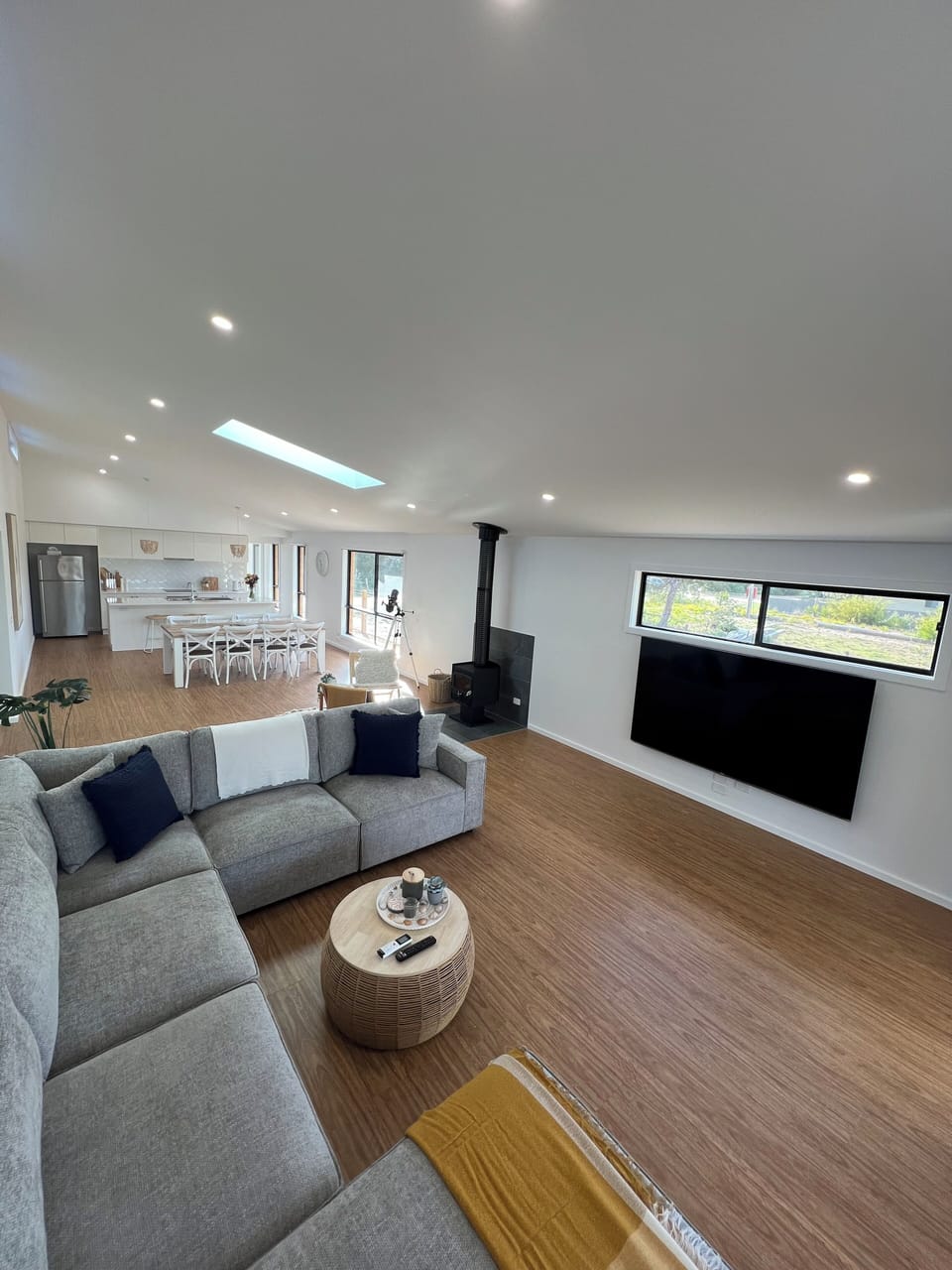 Our home! 85inch smart TV, plush massive couch and lots of natural light