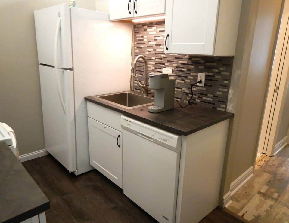 This is the right half of the kitchen.  You can see the dishwasher and refrigerator, both less than three years old.  The cupboard to the top right is where we leave some treats for you to enjoy.