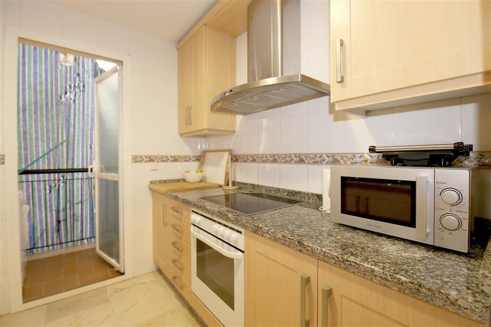 Another view of the fully-fitted kitchen with laundry room to the rear