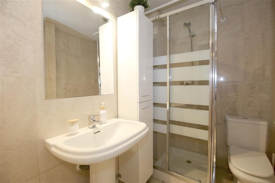 Family bathroom with shower, toilet and hand-basin