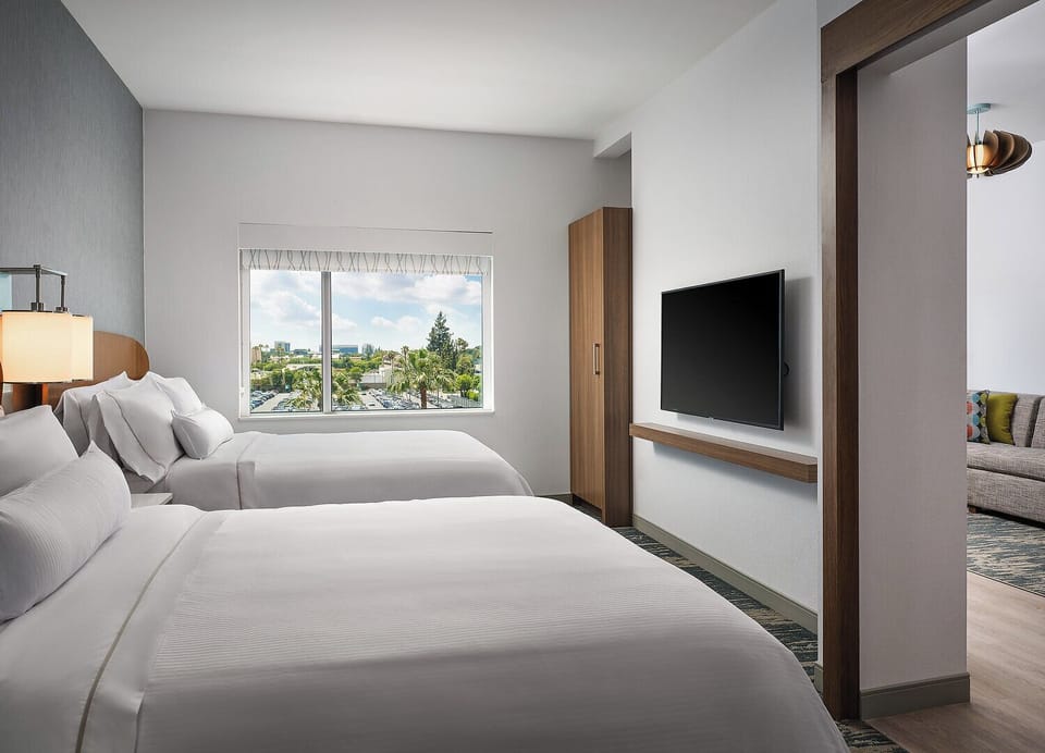 Wake up to sunshine and crisp linens in this airy room.