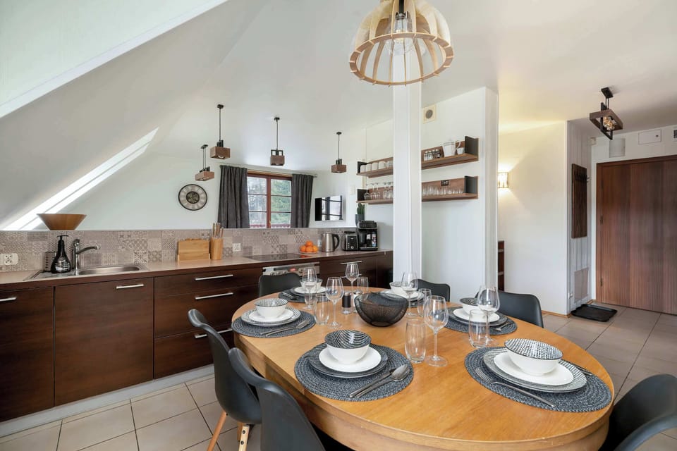 Modern kitchenette with elegant wooden cabinets and atmospheric ceiling lighting.