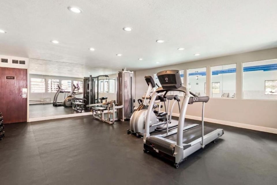 Energize your morning with a bright, well-equipped fitness room.