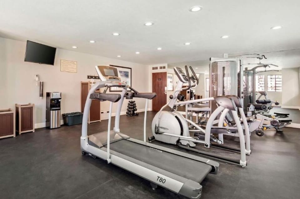 Stretch, lift, and recharge in a clean, open gym space.