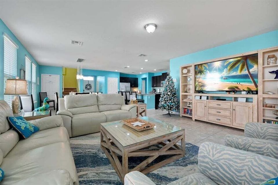 Relax with the whole family in our bright, coastal-inspired living area, designed for comfort and quality time after a day at the parks.