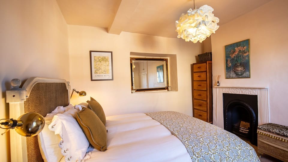 This bedroom features a king-size bed, Bell Cottage.