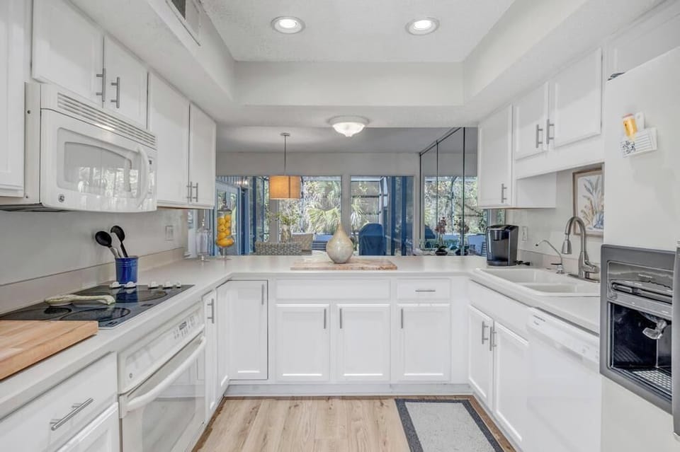 Spacious kitchen w/ island seating for casual dining or prep.