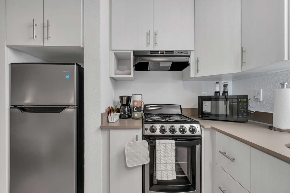 3D Panel with Yellow - Compact kitchenette with stove, microwave, and coffee maker