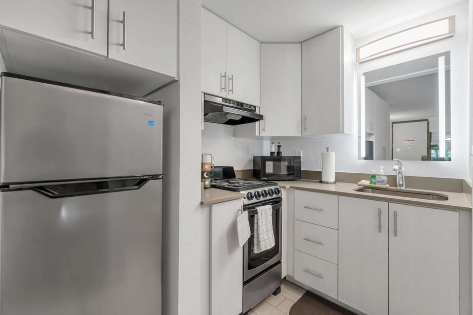 3D Panel with Yellow - Kitchen with stainless fridge, full stove, and storage space