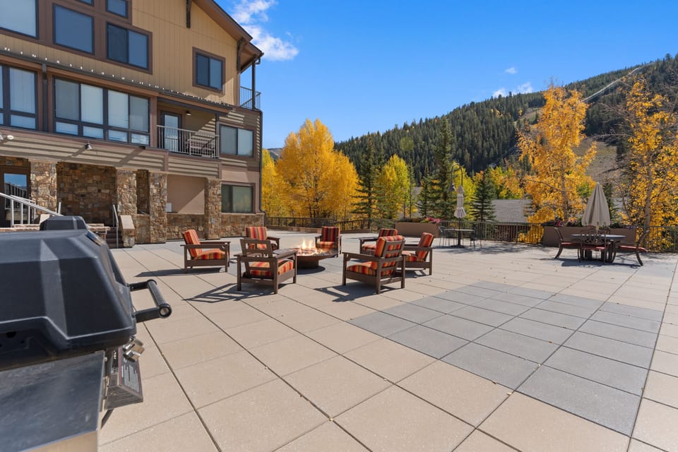 Gather around the fire pit on this expansive terrace, where golden aspens frame mountain views and comfortable seating beckons. Grill stations and multiple conversation areas make it perfect for crisp autumn evenings.