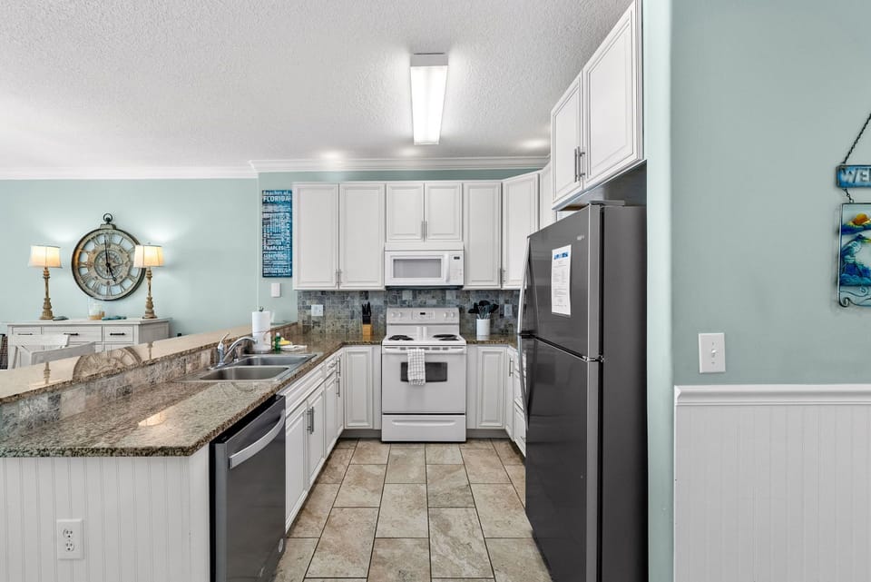 The fully equipped kitchen features granite countertops and has everything you need to prepare meals for family & friends.