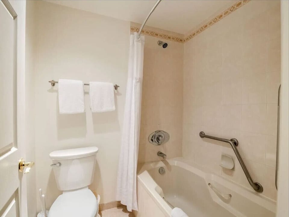 The en-suite bathroom includes a shower and bathtub combo, providing a relaxing space to refresh after skiing, biking, or exploring the mountains.