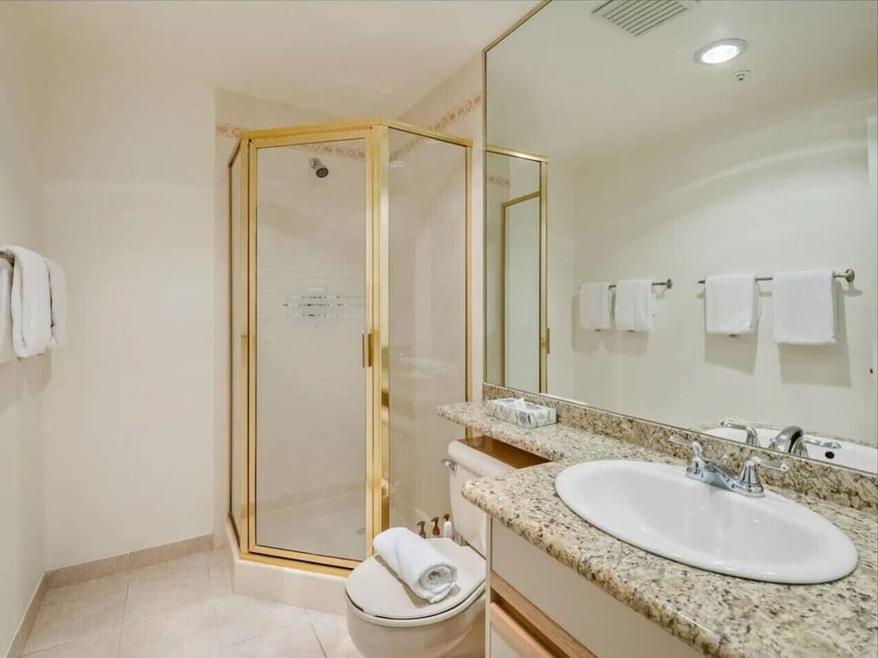 Your stay includes a contemporary bathroom with a crisp glass-enclosed shower—perfect for starting your day refreshed or ending it relaxed.
