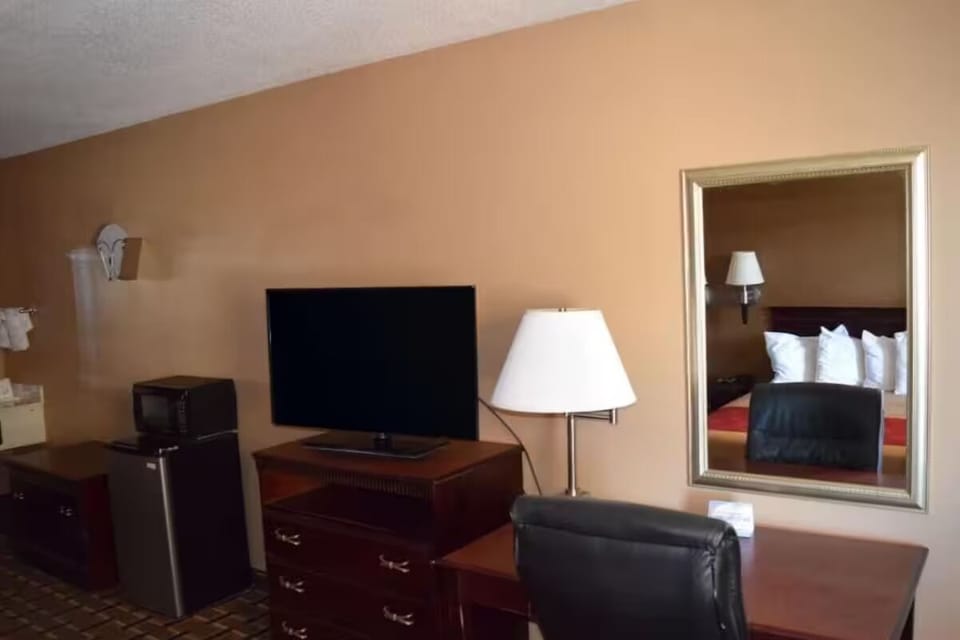 Kick back with in-room TV, fridge, and easy workspace.