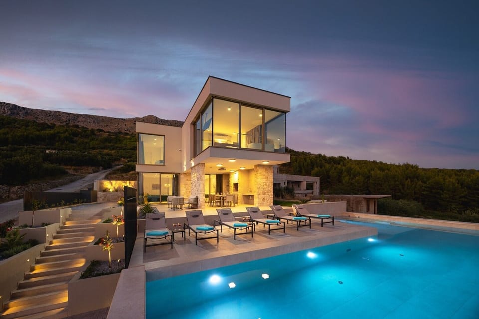 Evening shot of the two-level villa with pool area, part of the 203 sqm sophisticated living space.