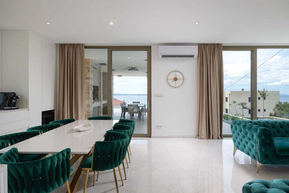 The fully air-conditioned living space includes the dining area and sliding doors that open to the outdoor patio.