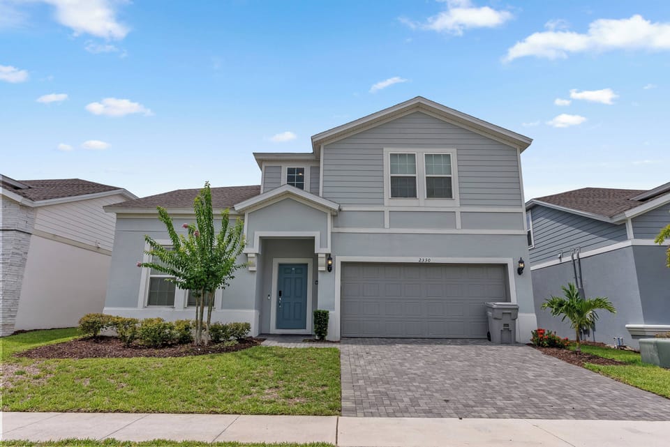 Discover the charm of our inviting blue exterior and manicured landscaping, perfect for relaxation. Step through the spacious entrance via the paver driveway and begin your vacation surrounded by serene greenery.