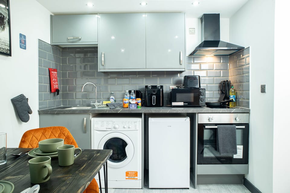 Spacious kitchen setup with storage, cooking facilities and integrated appliances, ideal for self-catering stays.