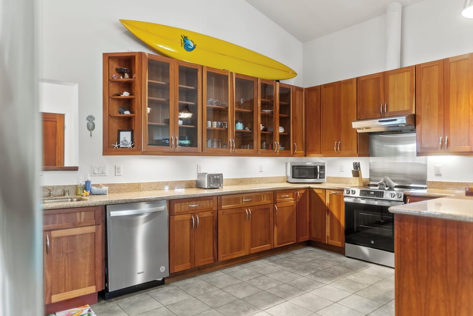 Chef-friendly kitchen with full appliances, surf-inspired decor, and ample storage.
