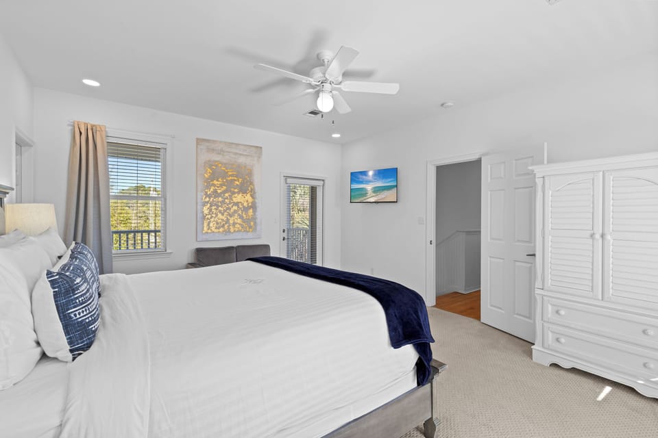 Drift off to sleep in your bright master suite with ceiling fan, private balcony access, and ample storage.