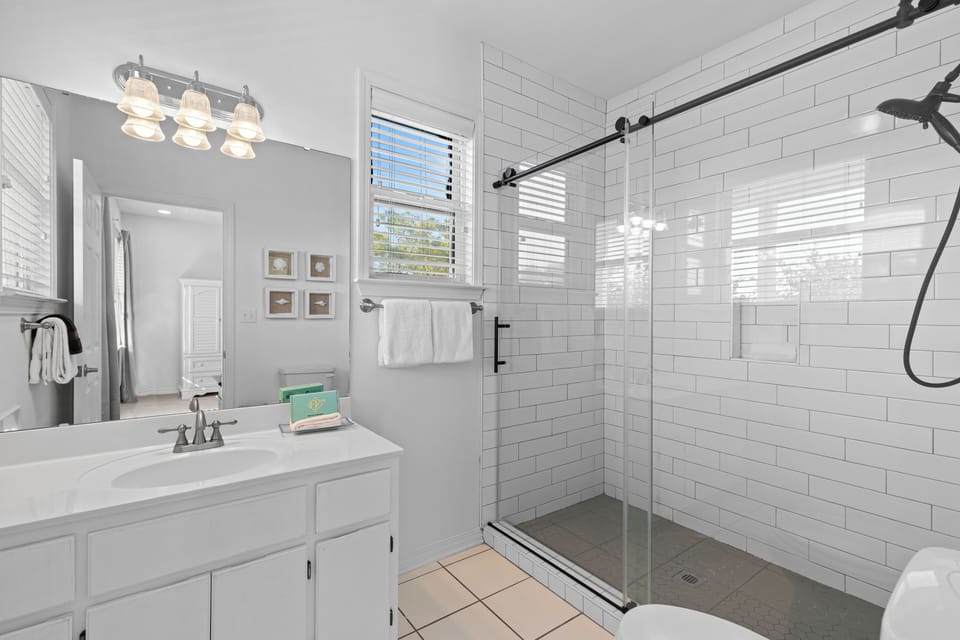 Unwind in your private spa-like bathroom featuring a spacious walk-in shower with elegant subway tile and modern fixtures.