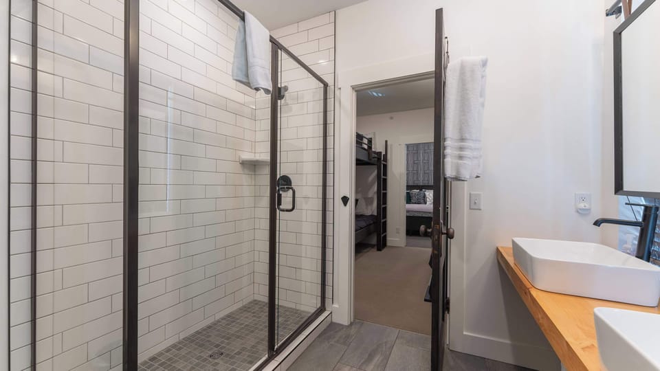 Elegant bathroom showcasing a freestanding-style soaking tub, contemporary vanity, polished fixtures, and refined finishes, creating a relaxing space to refresh and unwind.