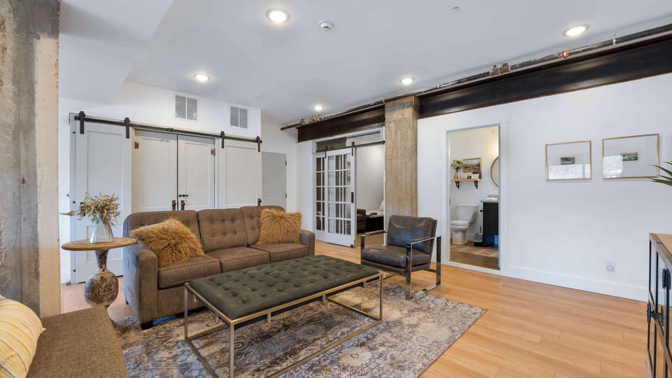 Comfortable Gathering Space — Spacious living room with cozy seating, modern décor, and plenty of room to unwind together.