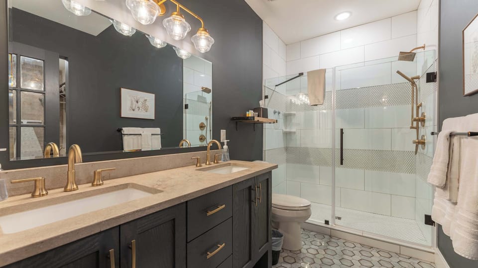 Modern Ensuite Bathroom — Beautiful bathroom with dual vanities, a soaking tub, and a glass-enclosed shower for a spa-like experience.