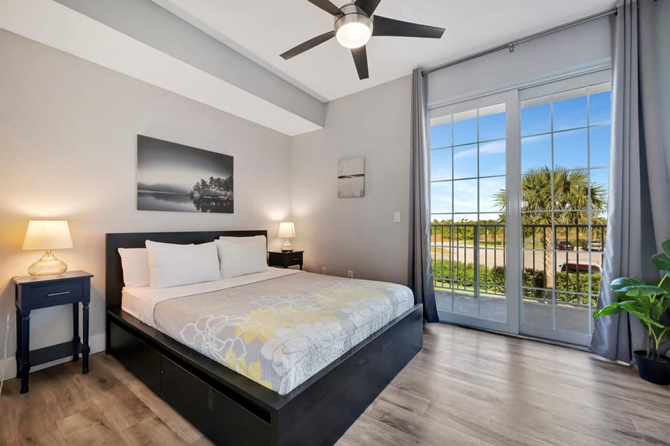 Bedroom with large windows and greenery views