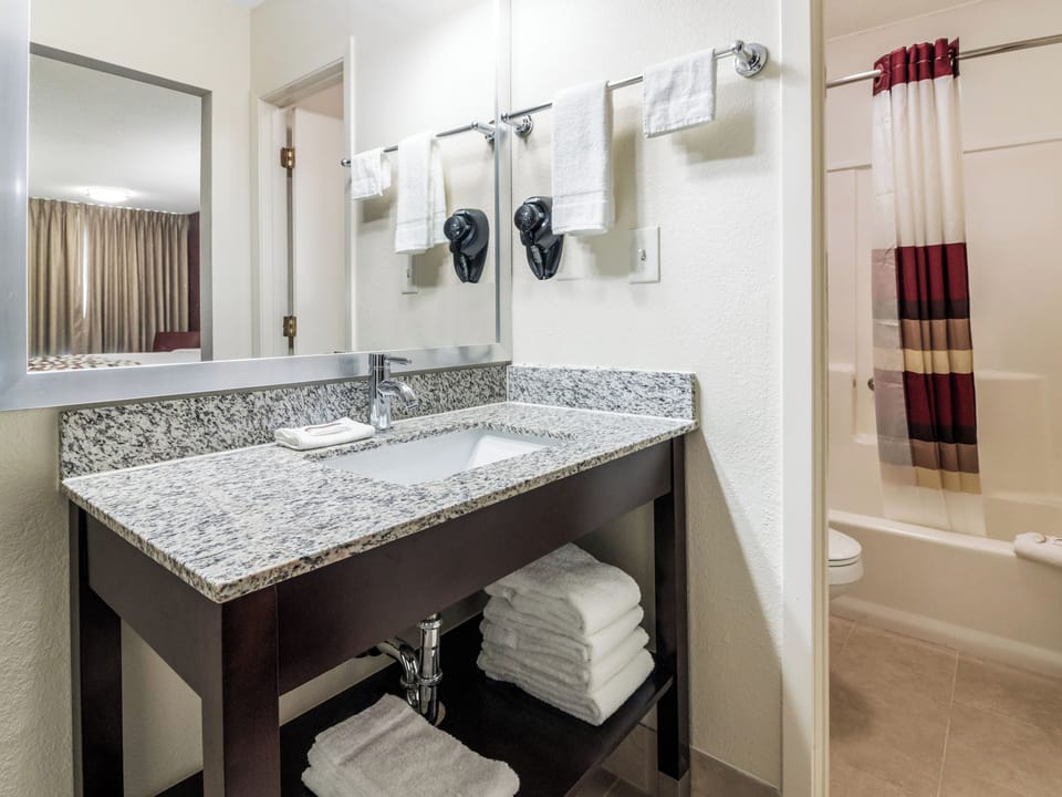 Refresh at the granite vanity, then rinse off in comfort.