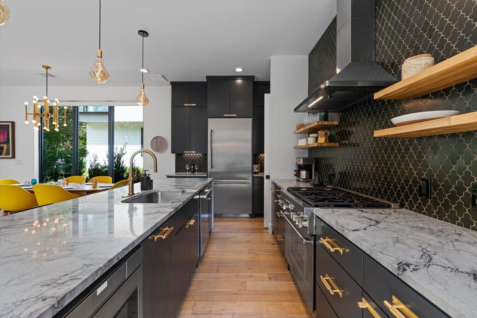 House#2: Sleek kitchen with complete amenities and a central island ideal for shared meals.