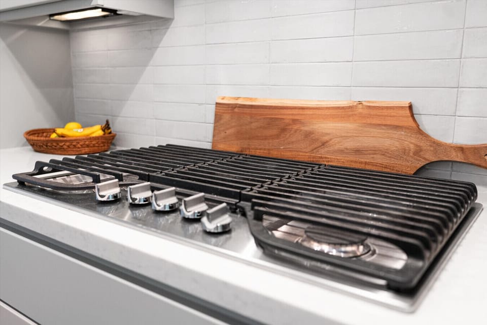 House#1: Sleek stove in a modern kitchen, designed for efficient cooking and easy meal preparation.