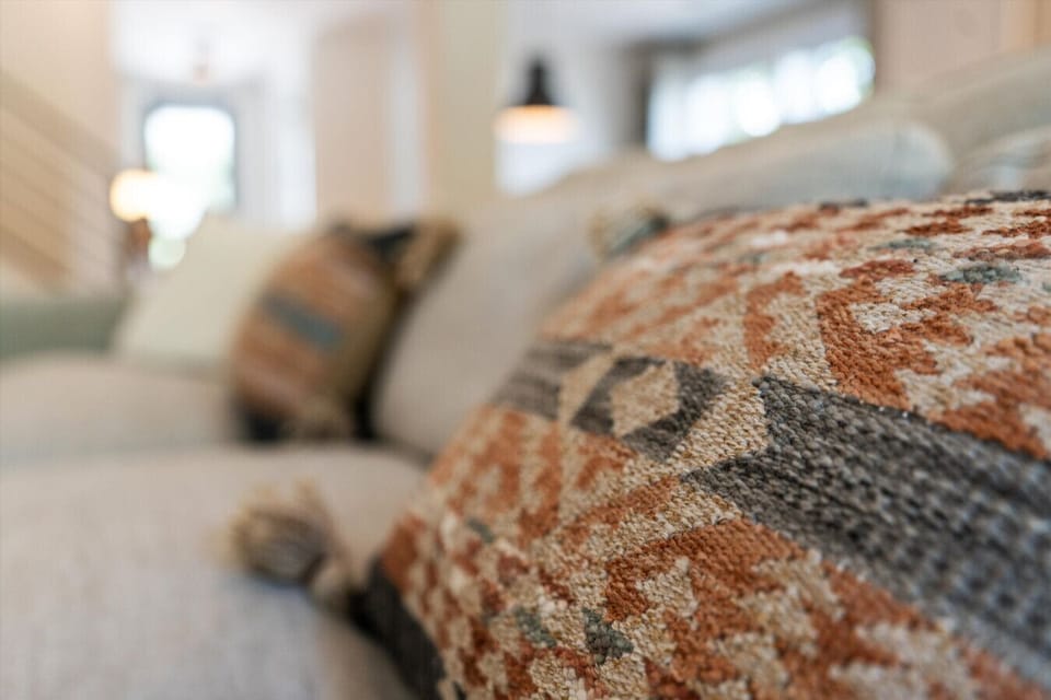House#1: Soft, plush pillows that invite you to sink in and relax.