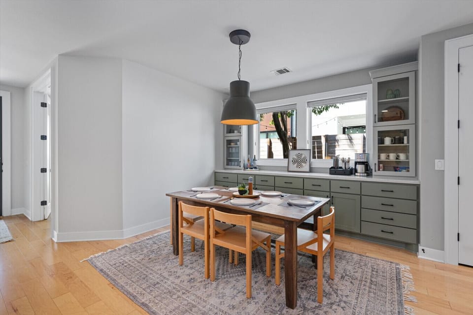 House#1: Chic dining area with a stylish table, bathed in natural light, perfect for gatherings and intimate dinners.