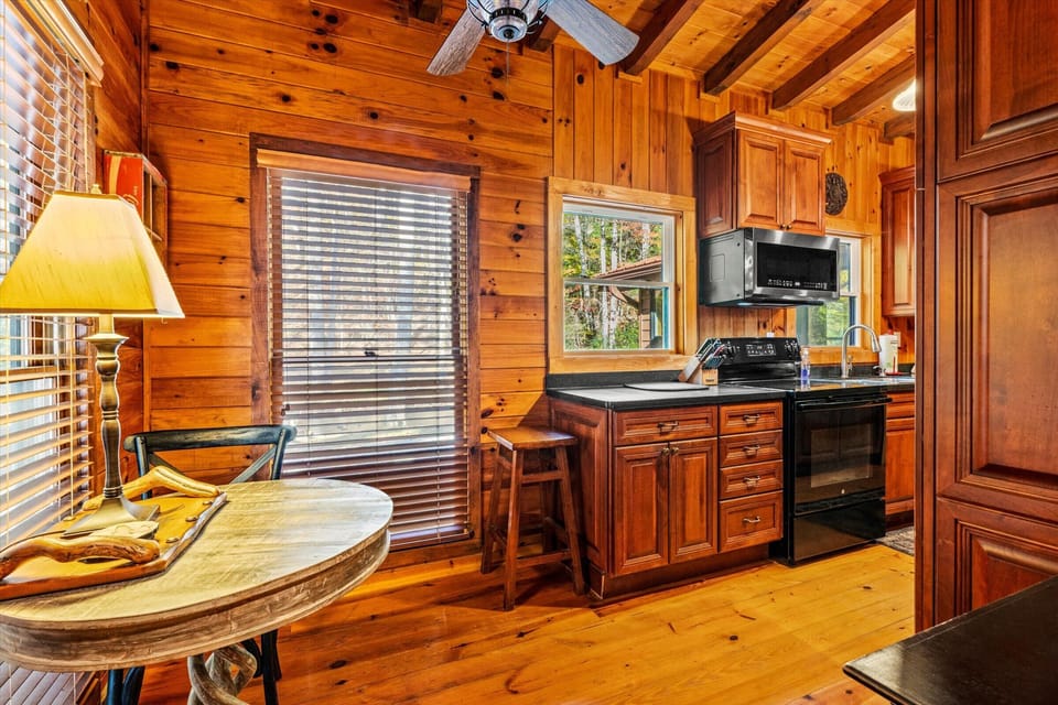 Sip your morning coffee with forest views pouring through sunlit windows in this warm, all-wood kitchen nook.