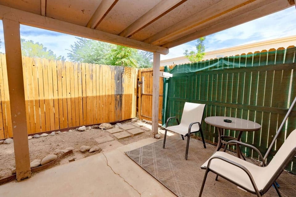 Private, covered rear patio area. Perfect for outdoor meals, early morning coffee time or for a smoke break (please do not smoke or vape inside).