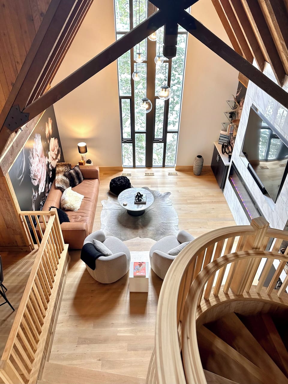 Cozy family room with fireplace, smart TV, cathedral ceiling, hardwood floors.